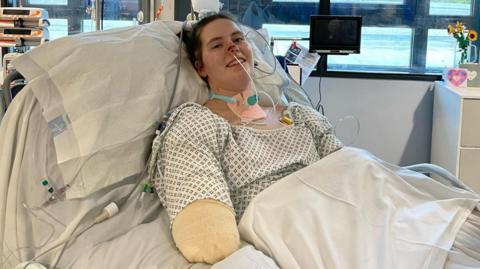 Lily in a hospital bed after having all four limbs amputated