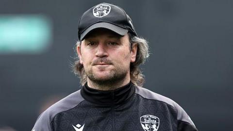 Craig Harrison looks on from the touchline