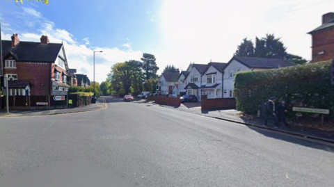A junction of two roads in a residential area.
