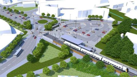 Artist's impression of the new train station in Portishead, seen from above. A train is seen coming into a station with a car park behind the station.