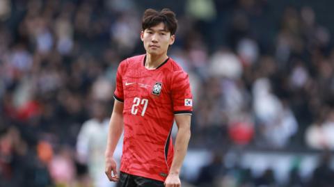 Bae Jun-ho, wearing South Korea's red kit with black accents, playing during the side's international friendly against Ivory Coast in March