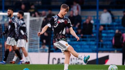 Manchester United youngster Jim Thwaites warms up before match