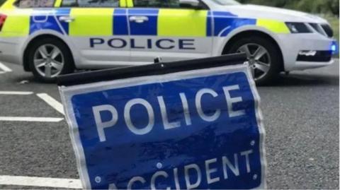 Police accident sign and police car in the background