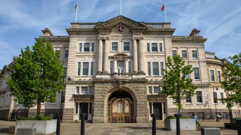 Kent County Council's grey, stone County Hall building in Maidstone, pictured on a clear day.
