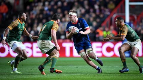 Joe Batley with the ball surrounded by three South Africa players