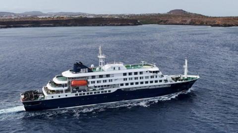 A drone view of the cruise ship MV Hondius, carrying passengers suspected of having cases of hantavirus on board. Big white and black vessel off Cape Verde. 
