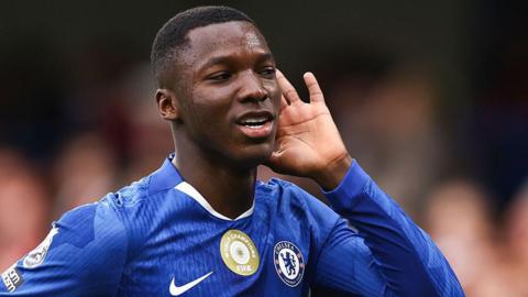 Moises Caicedo cups his hand to his ear to celebrate his goal against Liverpool