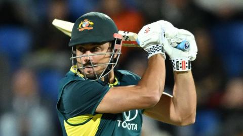 Marcus Stoinis raises his bat after reaching 50 against Pakistan