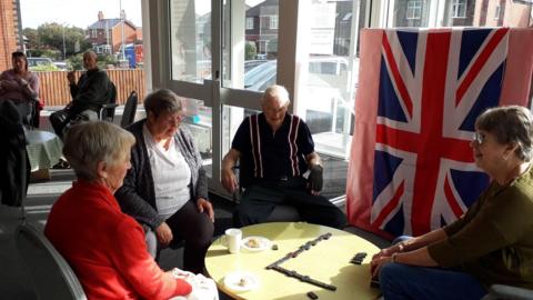 A view of a "Place of Welcome" session at Big Barn Lane Methodist Church in Mansfield with four people sat chatting around a table. (From 13 February 2023).