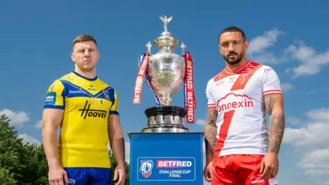 Warrington's George Williams with Hull KR's Elliot Minchella and the Betfred Challenge Cup trophy