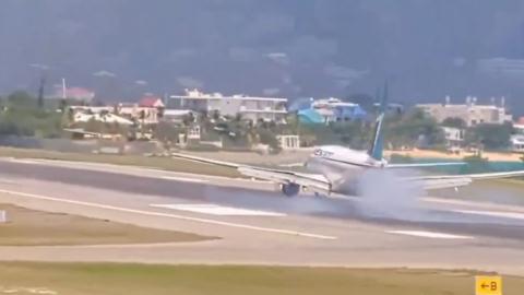Plane landing with smoke behind it 
