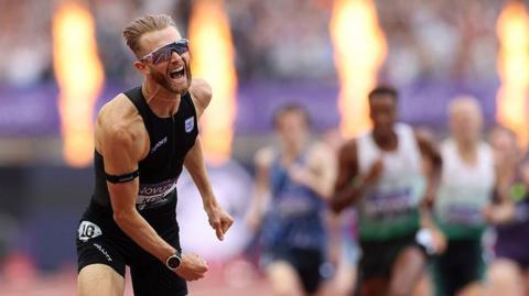 British athlete Josh Kerr cheers and celebrates whilst crossing the finish line at the London Stadium during a Diamond League event.