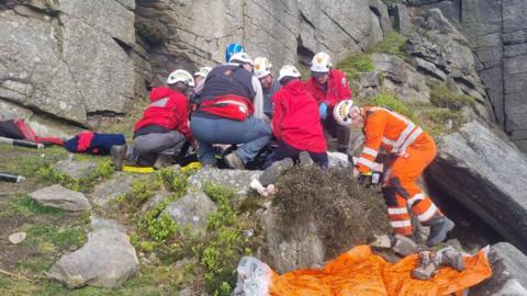 Mountain rescue volunteers helping a casualty