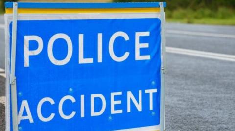 A police accident sign pictured in close-up at the side of a road