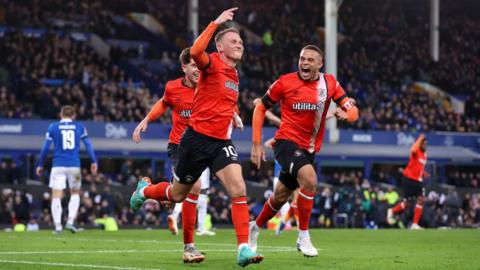 Cauley Woodrow celebrates with his team mates