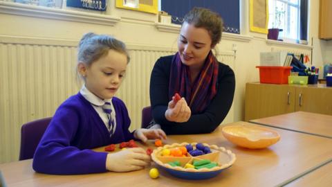 Teaching assistant Stacey with a pupil.
