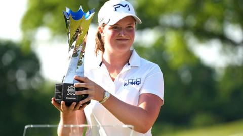 Lottie Woad holding the trophy