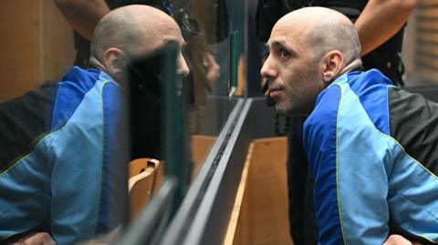 Cédric Jubillar behind a glass pane in court on Monday