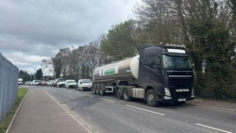 A milk tanker is seen on a road at the front of a convoy of vehicles who took part in a protest in Strabane on Saturday afternoon in protest at the rising cost of fuel
