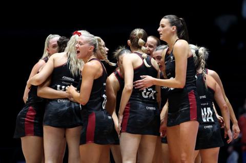 Wales netball players in a huddle