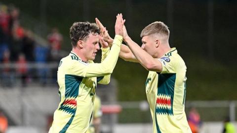 Nathan Broadhead and Jordan James high-five