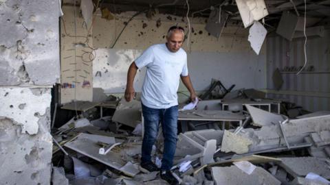 An Israeli inspects a building damaged in Iran's 1 October attack