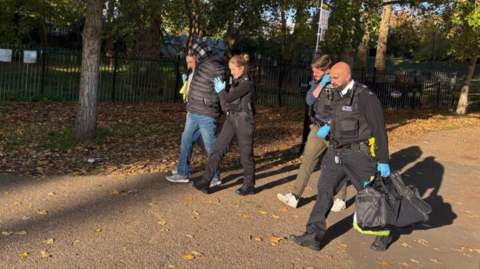 Hadush Kebatu being arrested in Finsbury Park being led away by police officers