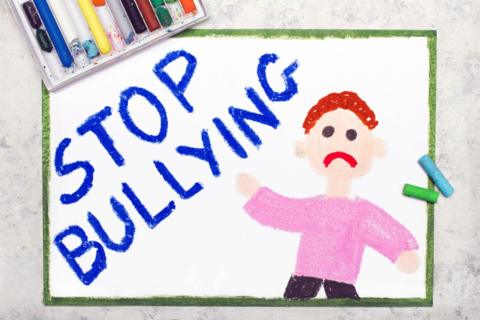 drawing of an unhappy person and the words stop bullying. 