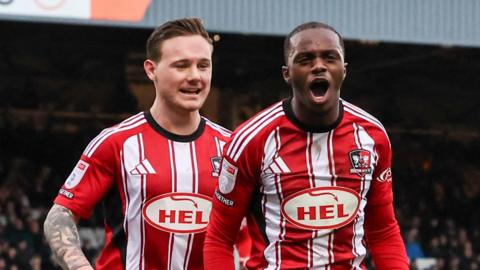 Exeter City's Carlos Mendes Gomes celebrates scoring the opening goal at Port Vale