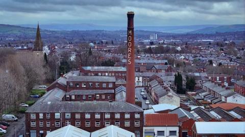 An aerial view of the historic Moores Hat Factory and homes in Denton on February 18, 2026 in Manchester, United Kingdom