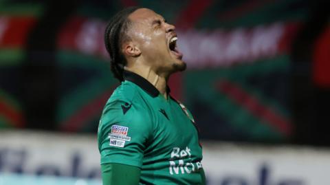 Kamson Kamara celebrates scoring for Glentoran