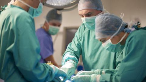 Surgeons operating on a patient