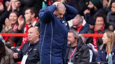 Ange Postecoglou holds his head