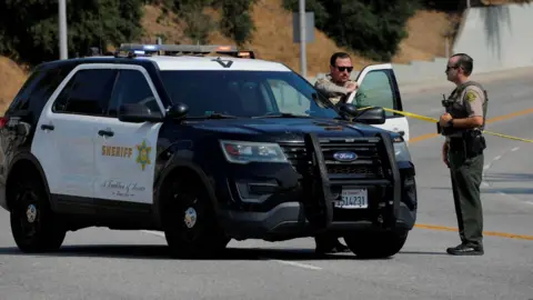 Police officers respond to a scene in Los Angeles