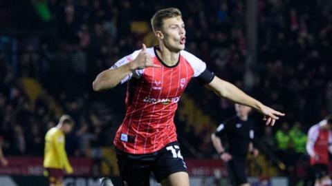 Lincoln's Erik Ring celebrates scoring the winner against Northampton