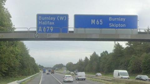 Generic image of the M65 motorway at Hapton near Burnley showing cars driving under a motorway gantry