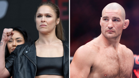 Ronda Rousey holds up her fist and is next to a shirtless Sean Strickland