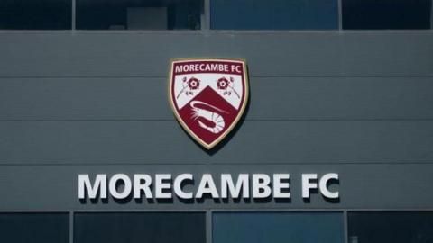 Morecambe's logo at their Mazuma Stadium home