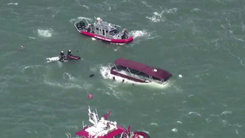 Aerial images of a sinking boat in San Francisco Bay surrounded by emergency response vessels.