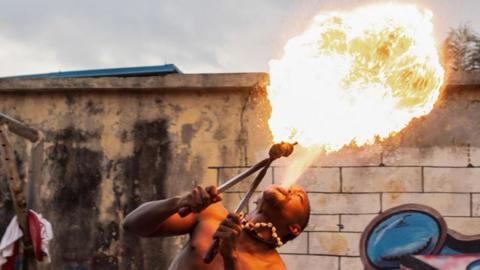 A fire breather performs during a slum party in Oworonshoki district of Lagos, Nigeria, 24 September, 2024