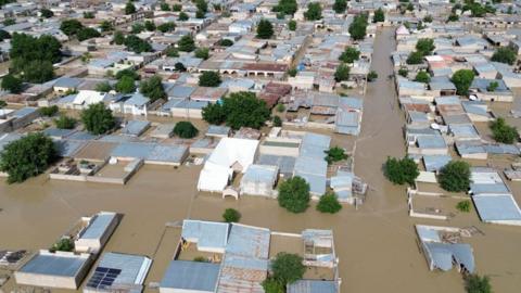 This aerial view shows houses submerged under water in Maiduguri on September 10, 2024