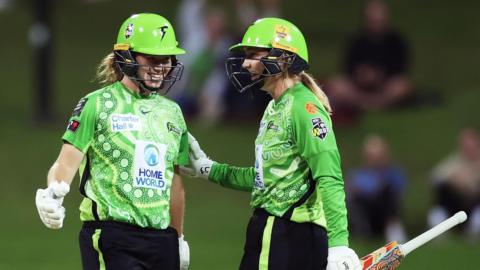 Hannah Darlington (L) and Anika Learoyd (R) of Sydney Thunder celebrate victory 