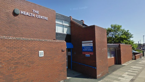 Castleford Health Centre - a brown brick building with blue NHS signs