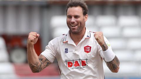 Doug Bracewell raises both fists in celebration after taking a wicket for Essex in 2023