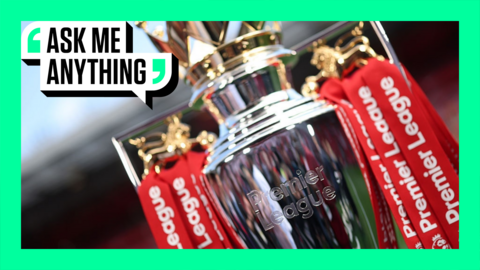 A close up of the Premier League trophy with red ribbons for Liverpool, 