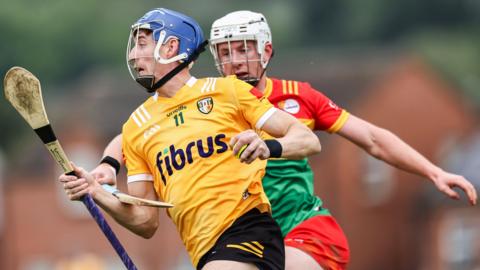 James McNaughton attempts to burst away from Carlow's Kevin McDonald at Corrigan Park