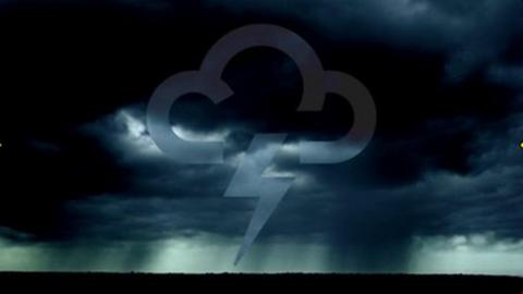 Inky black clouds in the sky with a 91ȱ Weather symbol with a lightning flash in the centre and the ground in silhouette below.