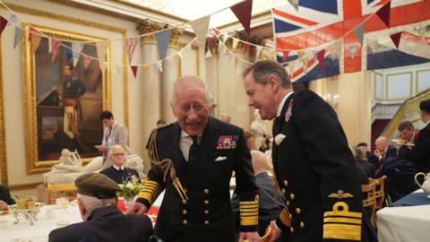 King Charles III (centre) at a tea party for Second World War veterans in Buckingham Palace, central London, following the military procession to mark the 80th anniversary of VE Day