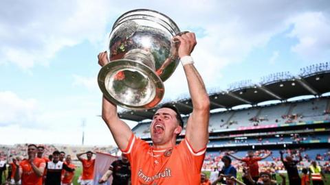 Stefan Campbell lifts the Sam Maguire Cup in front of the Armagh fans at Croke Park