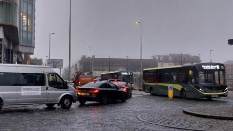 Traffic queues at the junction of Cookson Street and Talbot Road in Blackpool town centre on a grey, wet day